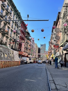 A lively street scene in a bustling U.S. city with colorful storefronts and happy visitors.