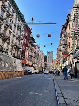 A lively street scene in a bustling U.S. city with colorful storefronts and happy visitors.