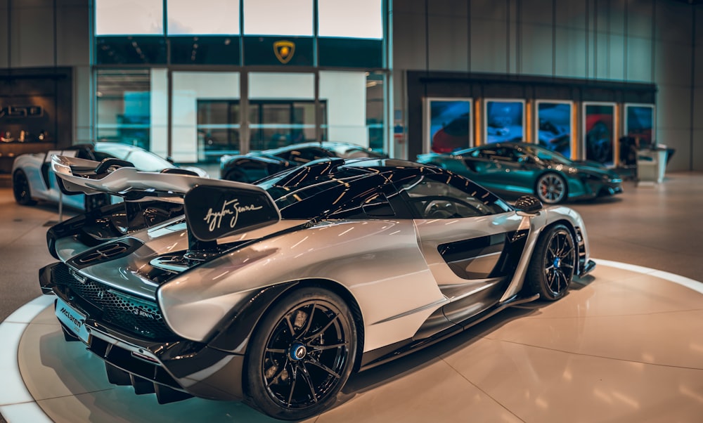 a group of cars are on display in a showroom