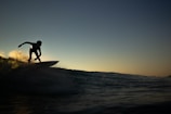 Surfer catching a wave at sunrise on Playa El Tránsito