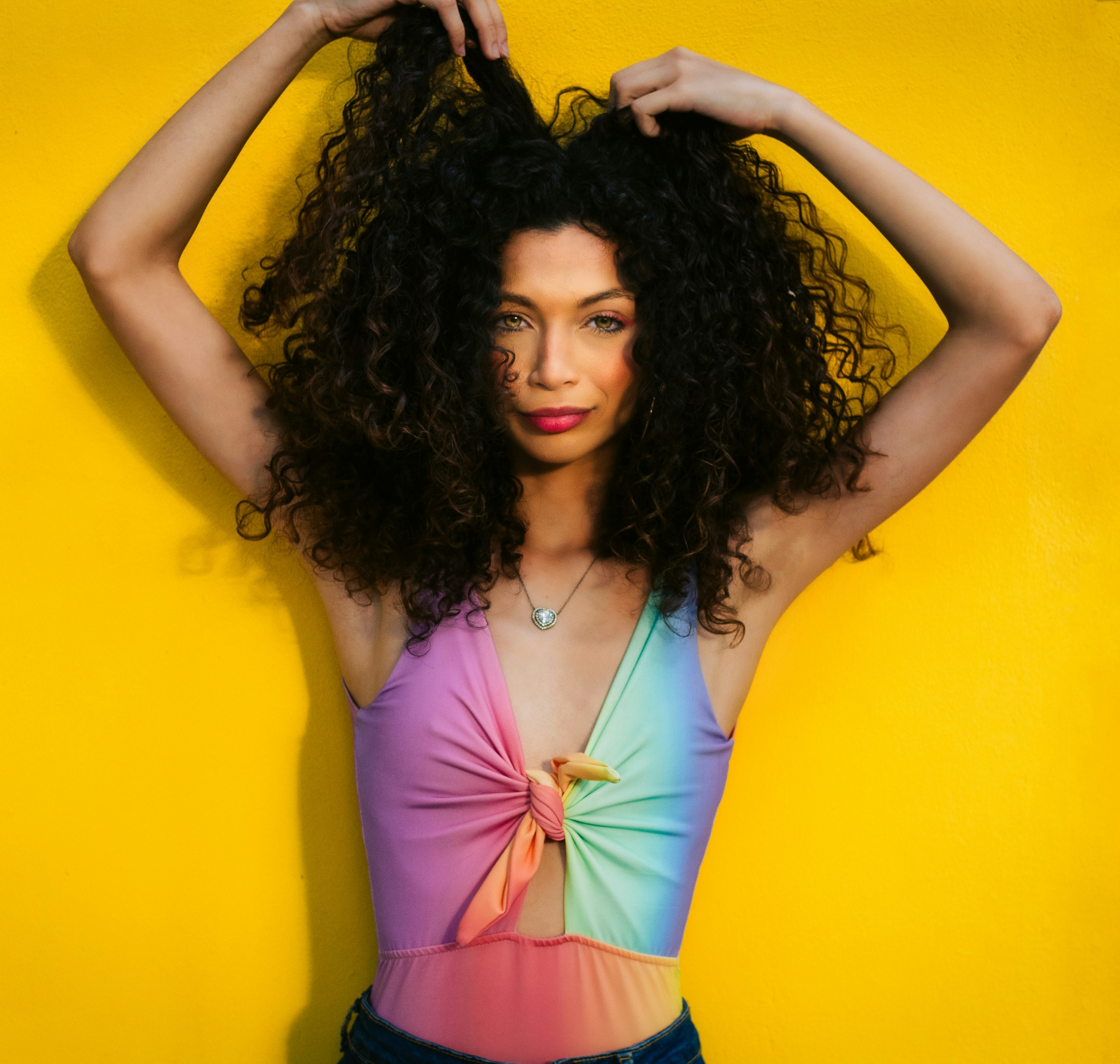 a woman with curly hair posing for a picture