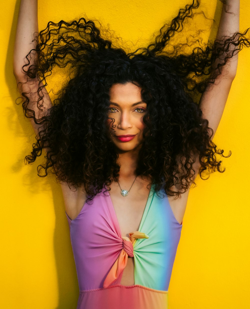 a woman with curly hair is posing for a picture