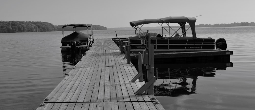 a black and white photo of a boat dock