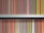 A neatly organized bookshelf displays a collection of brightly colored book spines, each predominantly featuring bold stripes with titles printed along the vertical edge. The books are primarily classic literature from a well-known publisher, with repeating small logo icons visible at the base of each spine.