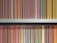 A neatly organized bookshelf displays a collection of brightly colored book spines, each predominantly featuring bold stripes with titles printed along the vertical edge. The books are primarily classic literature from a well-known publisher, with repeating small logo icons visible at the base of each spine.