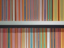 A neatly organized bookshelf displays a collection of brightly colored book spines, each predominantly featuring bold stripes with titles printed along the vertical edge. The books are primarily classic literature from a well-known publisher, with repeating small logo icons visible at the base of each spine.