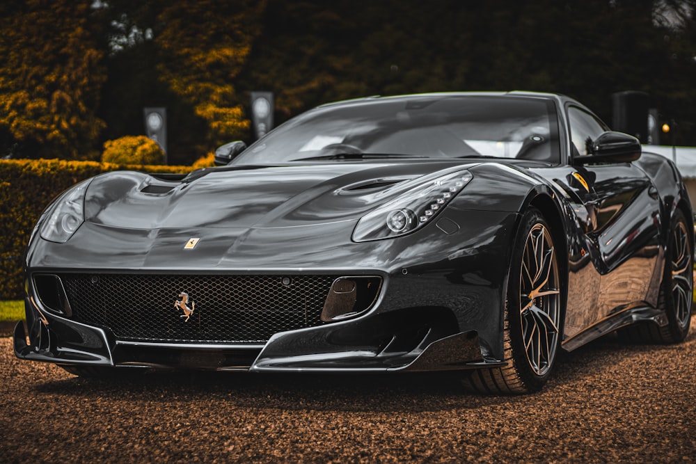 a black sports car parked in a driveway