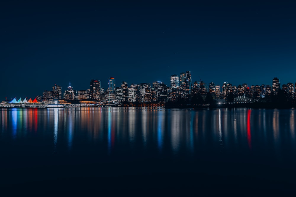 a city skyline is lit up at night