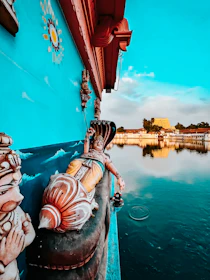 A vibrant mural depicting pharaohs and gods painted on a temple wall, rich with blues and golds.