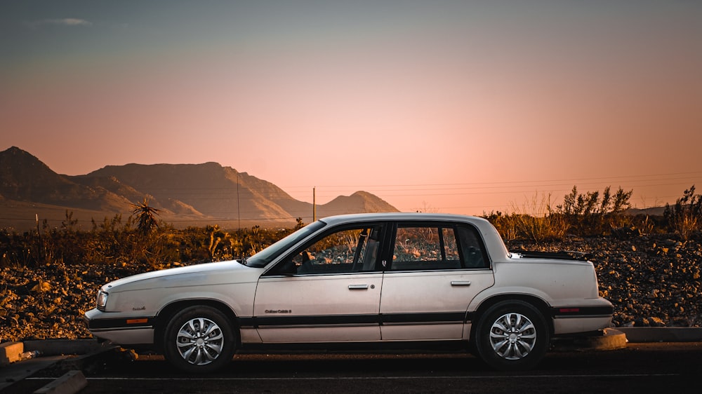 a white car parked on the side of the road