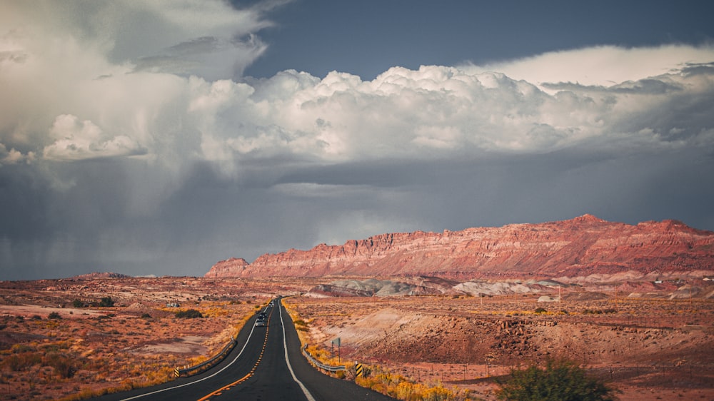 a long road with a mountain in the background