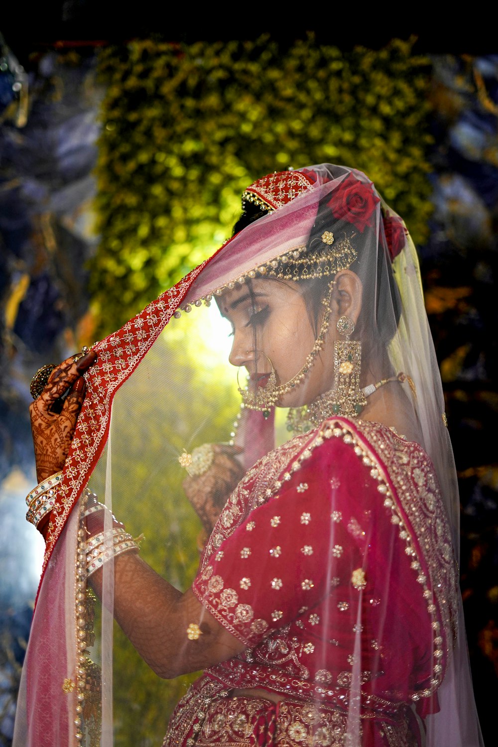 a woman in a red and gold wedding outfit