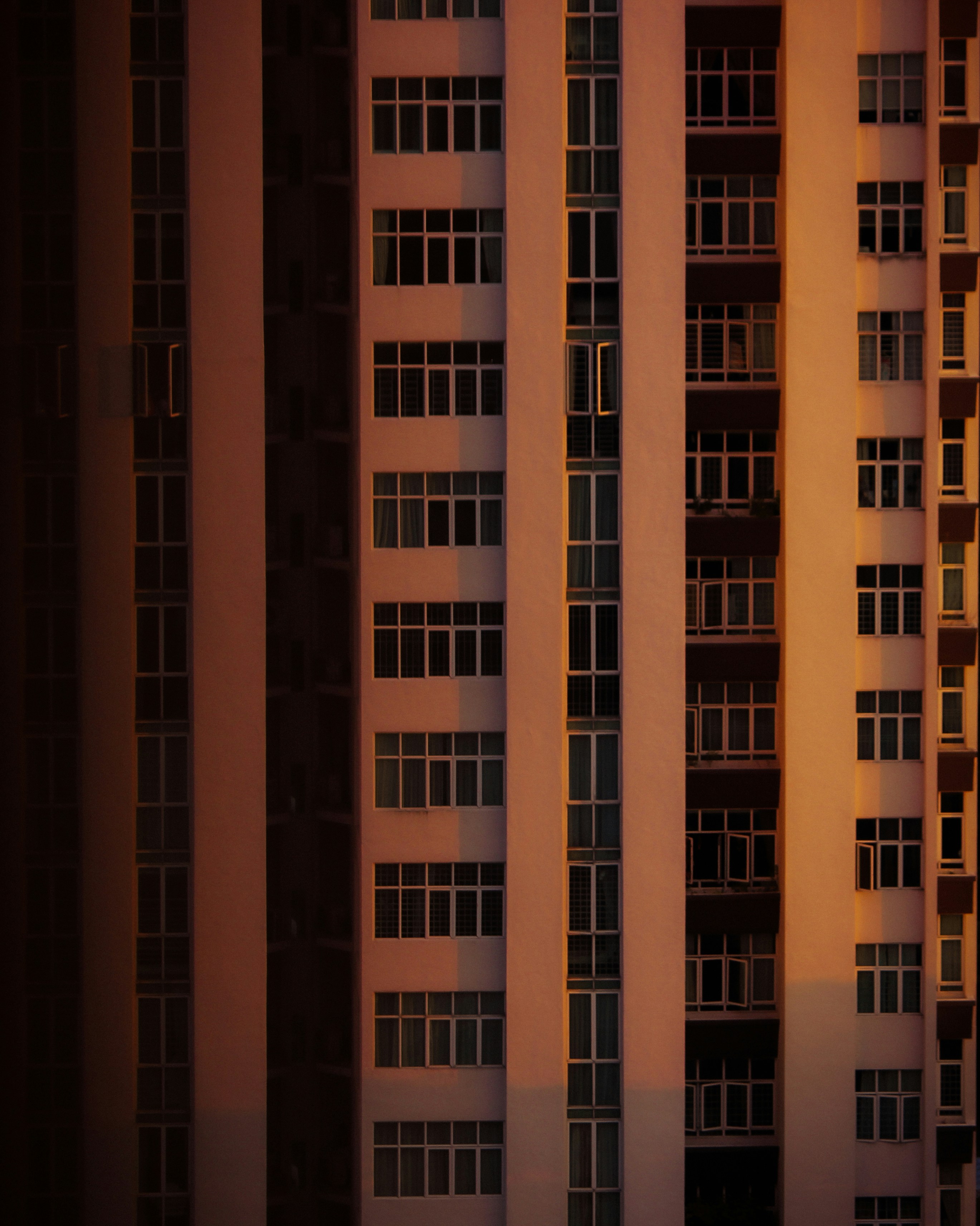 a tall building with lots of windows next to a street