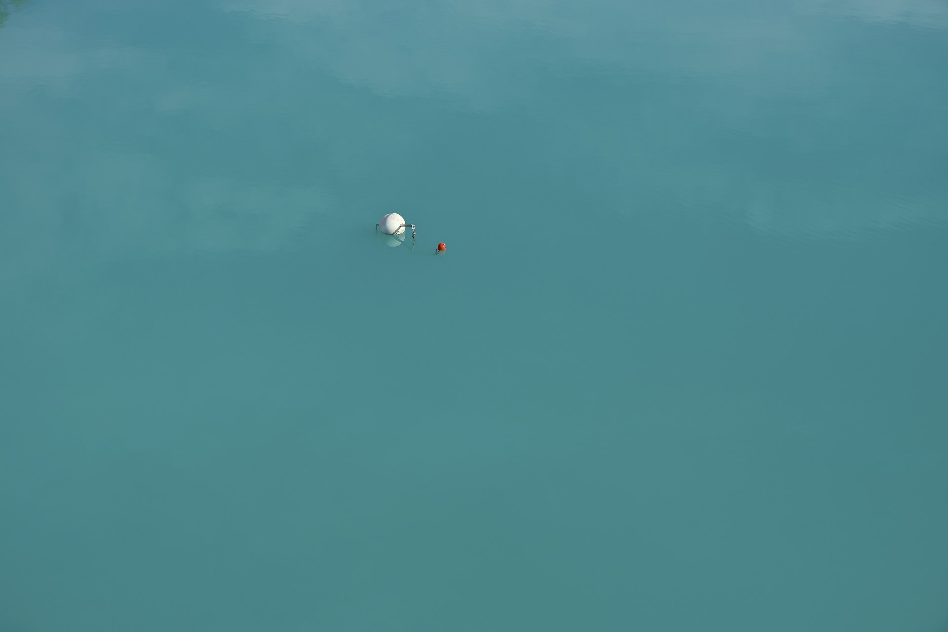 a large body of water with a white ball floating in it
