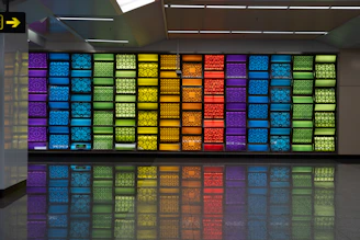 A sleek vertical wall print showcasing vibrant colors in a modern living room setting.