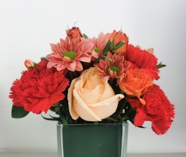 A vibrant bouquet of assorted flowers in a glass vase.