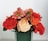 A vibrant bouquet of assorted flowers in a glass vase.