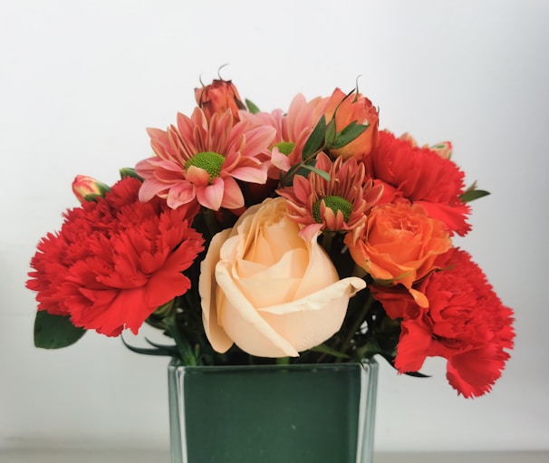 A vibrant bouquet of mixed fresh and imported flowers arranged beautifully in a rustic vase.