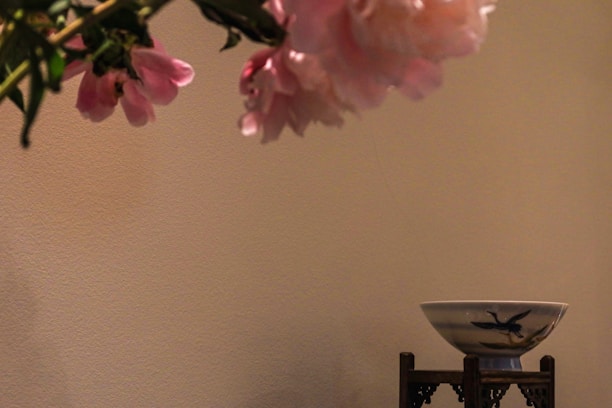 A serene arrangement of soft pastel flowers beside a glowing ziwei doushu chart.