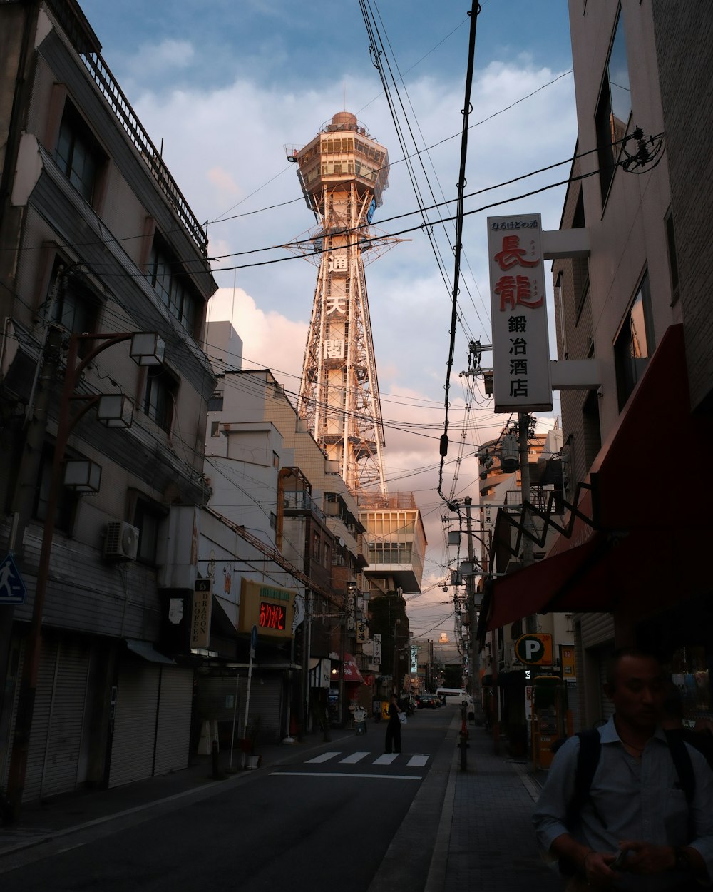 a tall tower towering over a city next to tall buildings