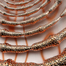 a close up of a metal object on a white surface