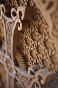a close up of a wooden carving of a clock