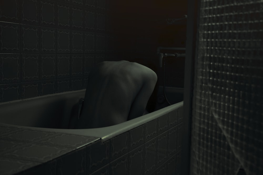 a person in a bathtub in a dimly lit room