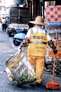 a man with a broom is walking down the street