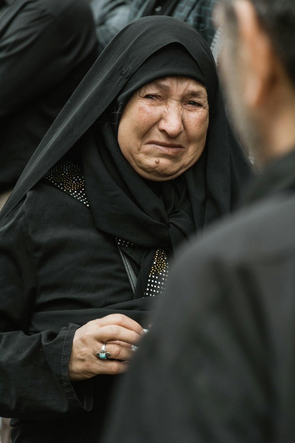a woman in a black hijab and a ring on her finger