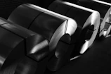 a black and white photo of rolls of steel