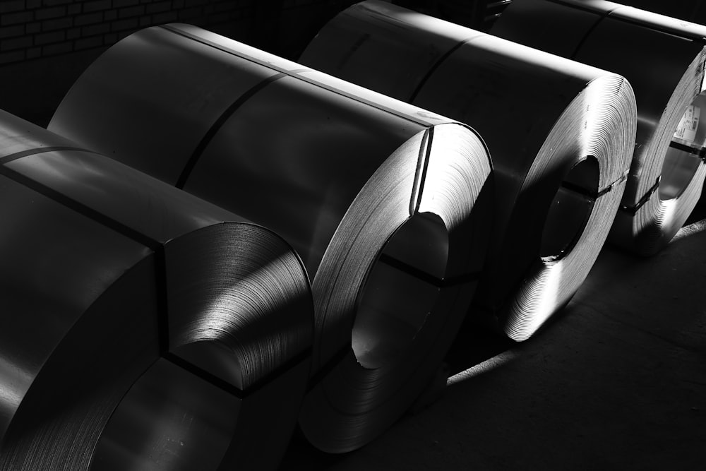 a black and white photo of rolls of steel