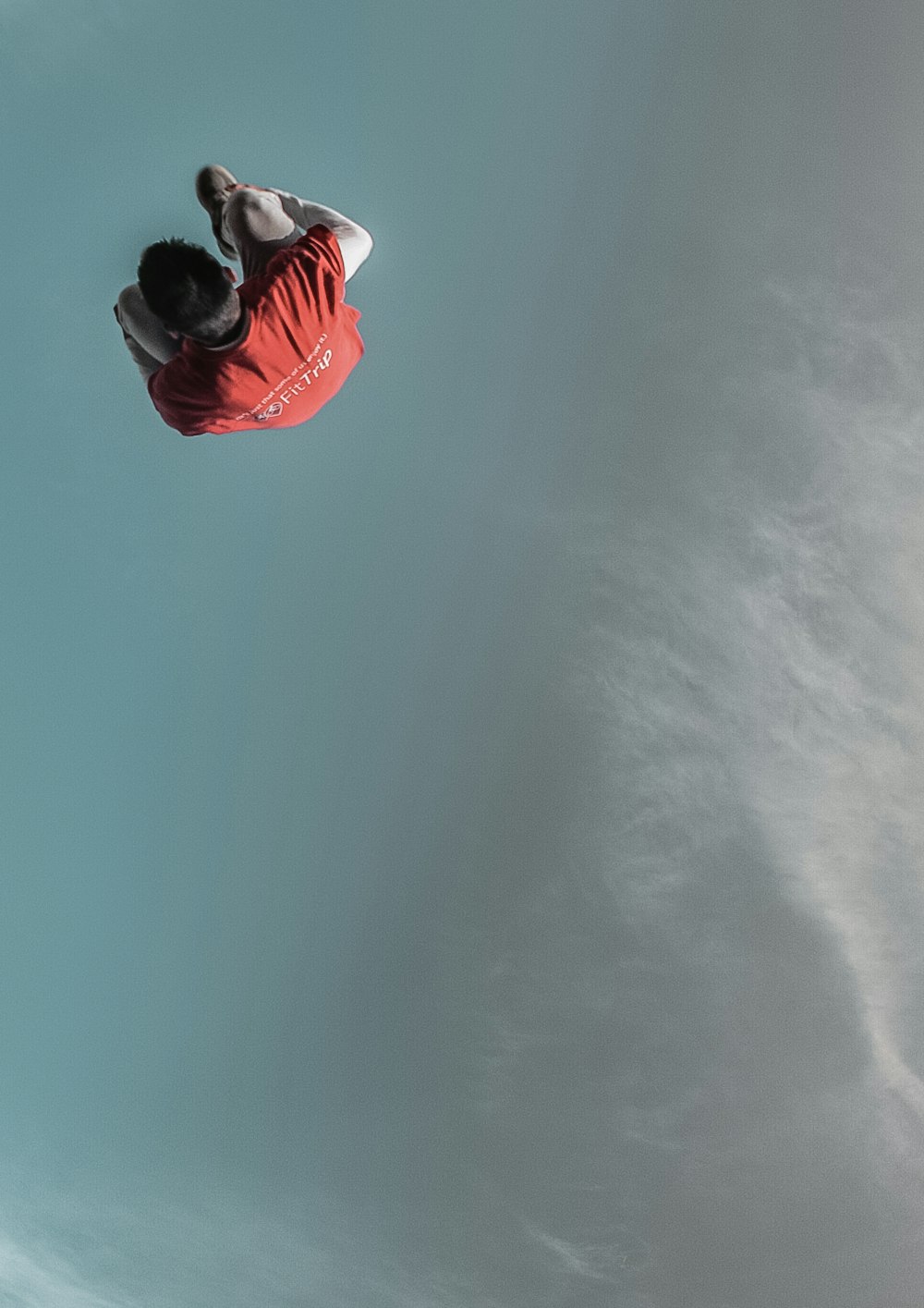 a man flying through the air while riding a snowboard