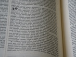 The image displays a close-up view of an open book, featuring a text layout in two columns with numbers indicating sections or verses. The page contains words that are clearly related to a religious text, mentioning terms like 'Sovereign LORD' and 'Israel'. The typography is traditional, suggesting a formal document.
