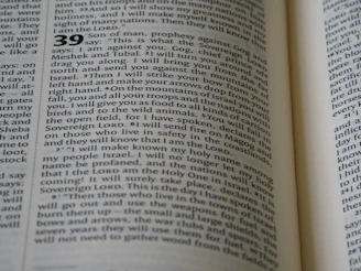 The image displays a close-up view of an open book, featuring a text layout in two columns with numbers indicating sections or verses. The page contains words that are clearly related to a religious text, mentioning terms like 'Sovereign LORD' and 'Israel'. The typography is traditional, suggesting a formal document.