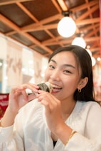 Happy customers enjoying rice balls at a cozy table inside the restaurant.