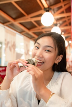 Happy customers enjoying rice balls at a cozy table inside the restaurant.