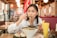 A smiling customer enjoying a bowl of ramen at green bear tasty japan.