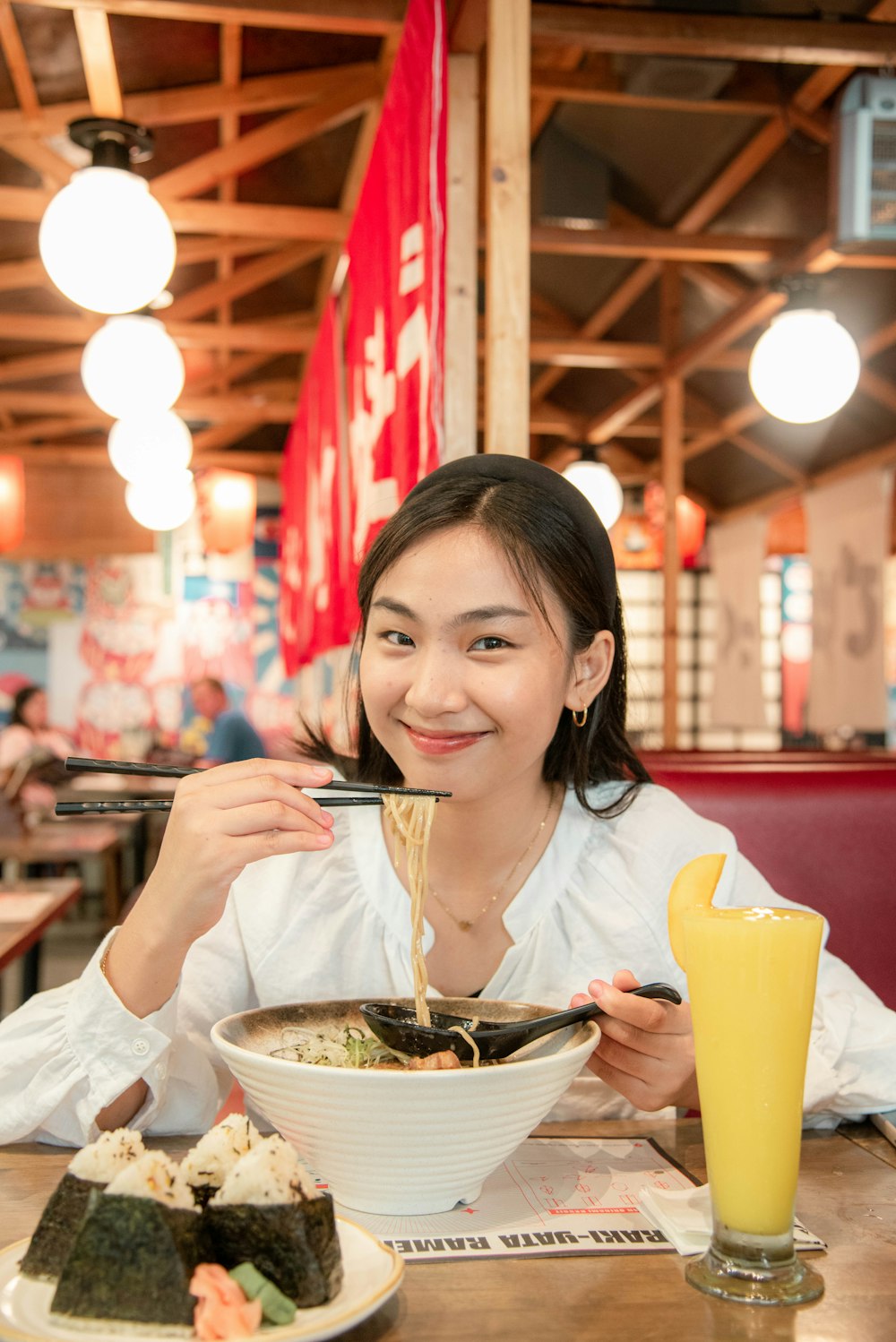 a woman sitting at a table with a bowl of food