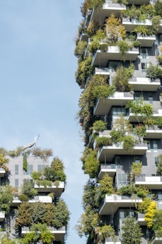 Modern building facade covered with lush vertical gardens under a clear sky.