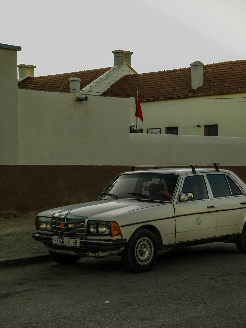 a white car parked in front of a building