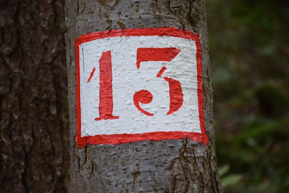 a close up of a street sign on a tree