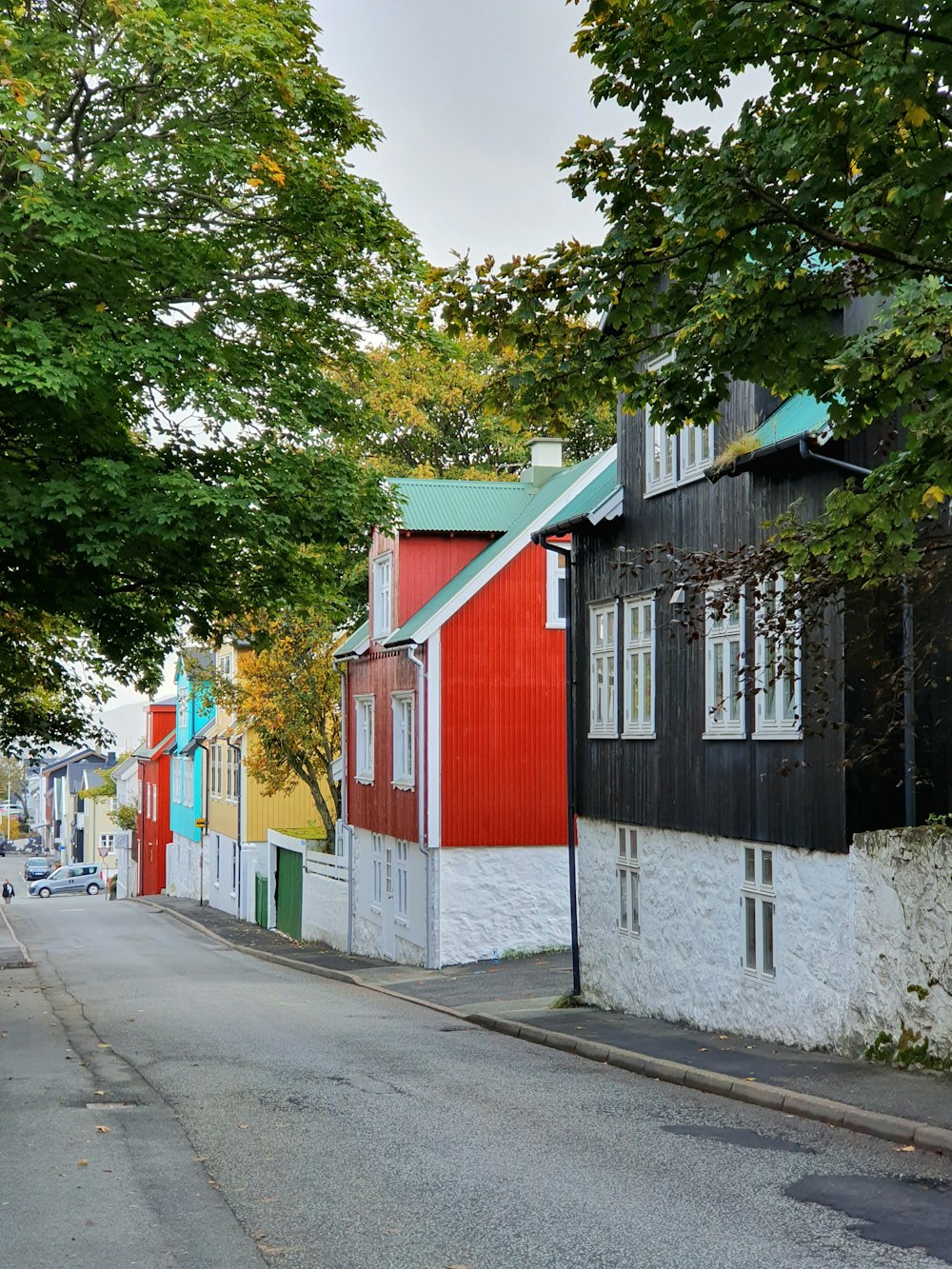 a street lined with colorful houses and trees
