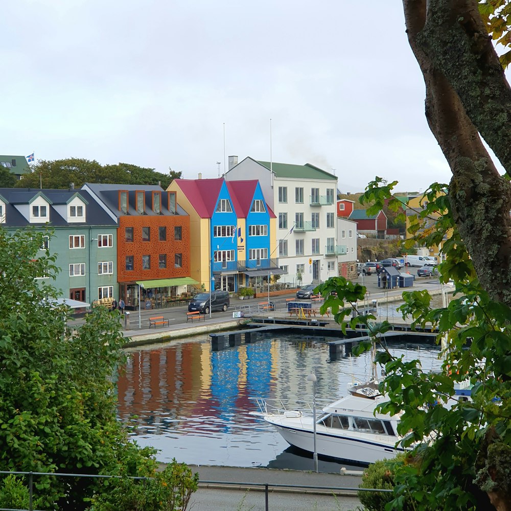 a harbor filled with lots of boats next to tall buildings