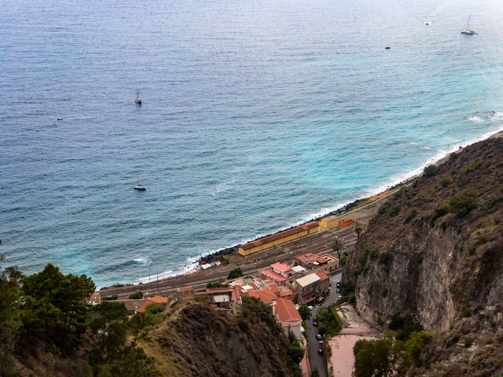 a view of a beach with a train on the tracks