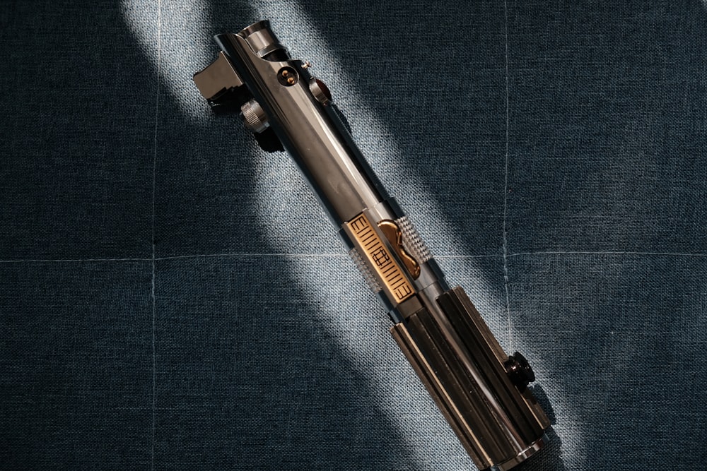 a gun laying on top of a blue cloth
