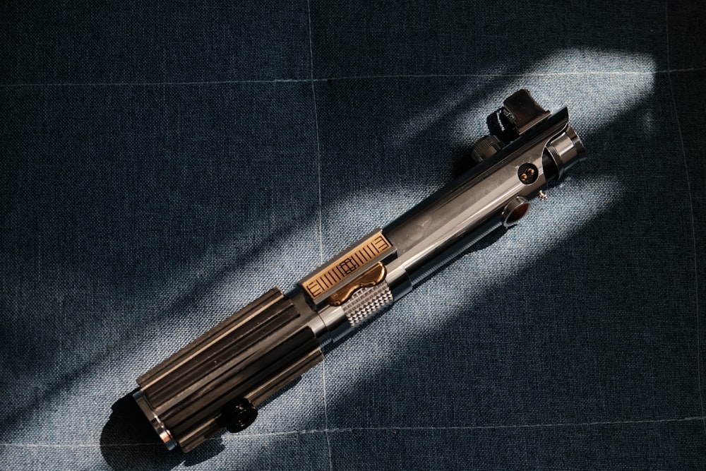a close up of a gun on a blue surface
