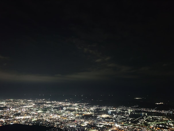 A cityscape overlayed with glowing map routes and data points illuminating connections.