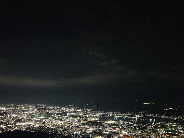 A sleek digital network map glowing over a minimalist city skyline at dusk.