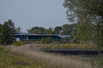 Completed small building designed for seismic resistance, surrounded by natural landscape.