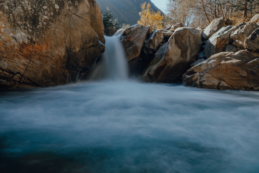 a stream of water running between two large rocks